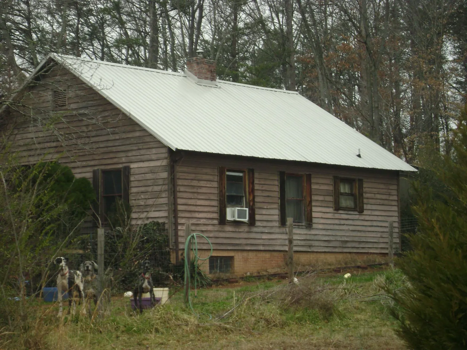 White metal roof on an old wood sided farmhouse, from a Metal Roof Installation job in Ravenna